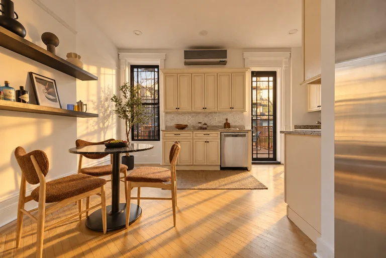 Kitchen breakfast area with a round table, cream cabinets and garden door at 731 Putnam