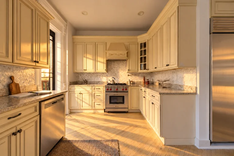 Kitchen with cream cabinets, stone counters and a stainless steel range at 731 Putnam