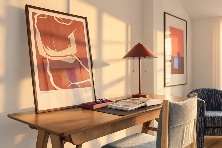 Wood office desk with framed artwork, a lamp and an open book at 731 Putnam